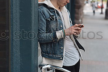 Similar – Image, Stock Photo Young urban man using smartphone in urban background.