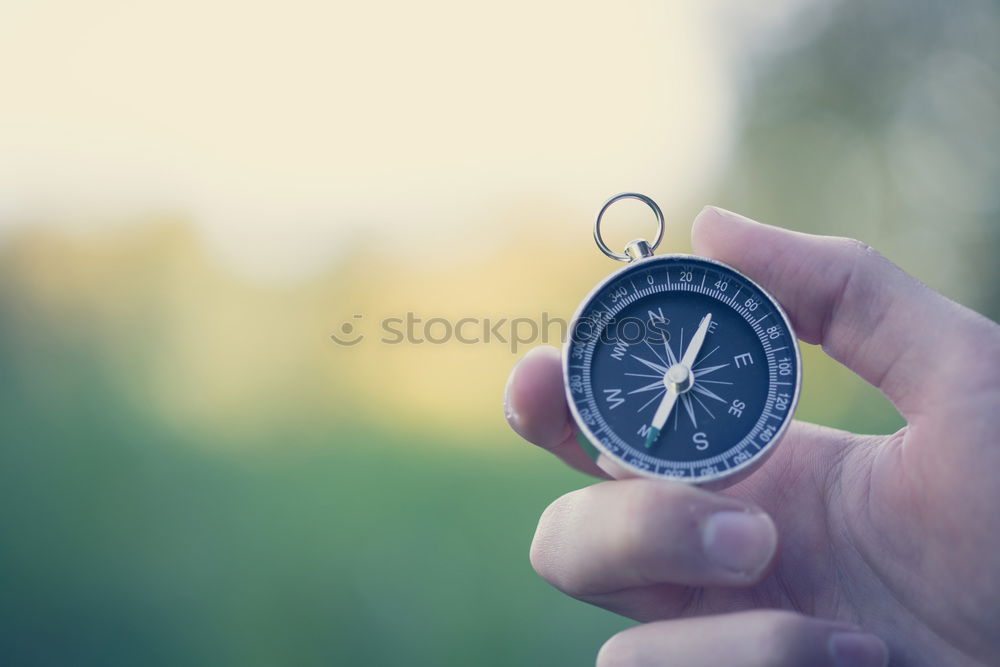 Similar – Image, Stock Photo Hand with compass at mountain road at blue sky