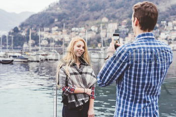 Similar – Image, Stock Photo two friends in the street taking pictures with mobile phone