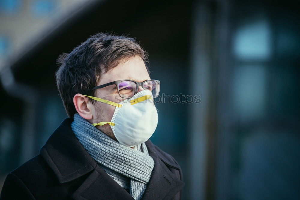 Similar – young woman wearing a mask and fogged glasses in autumn / winter (Corona / Covid-19)