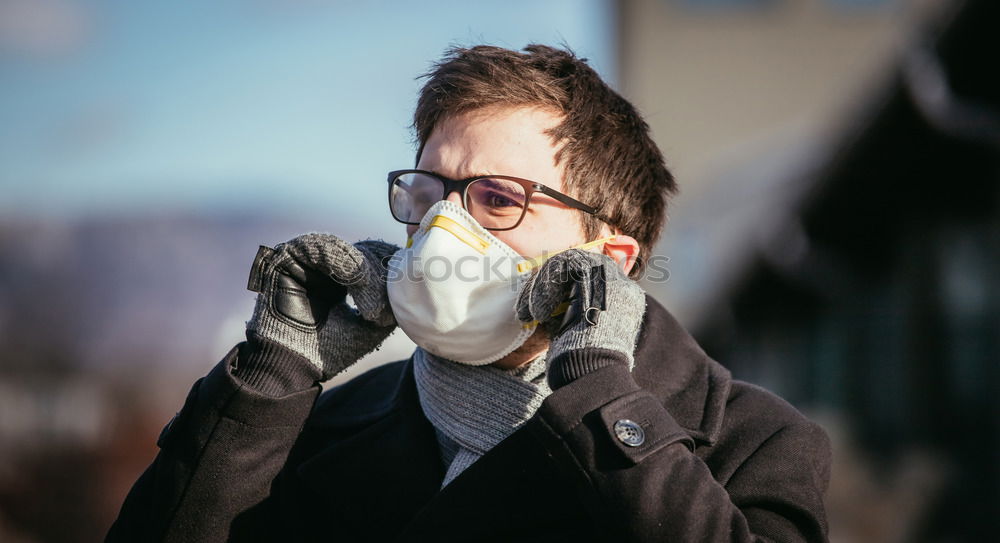 Similar – Young man standing in the city center wearing the face mask to avoid virus infection