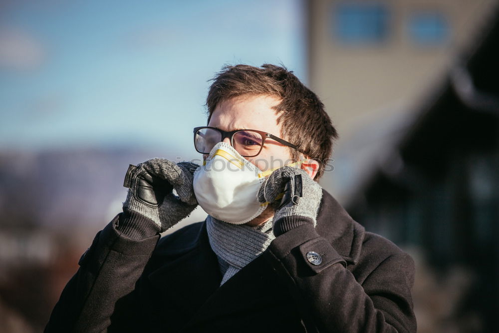 young woman wearing a mask and fogged glasses in autumn / winter (Corona / Covid-19)