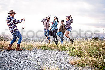 Similar – Image, Stock Photo Group of happy girlfriends having fun skateboarding
