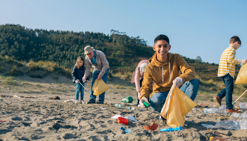 Similar – Young man cleaning the beach