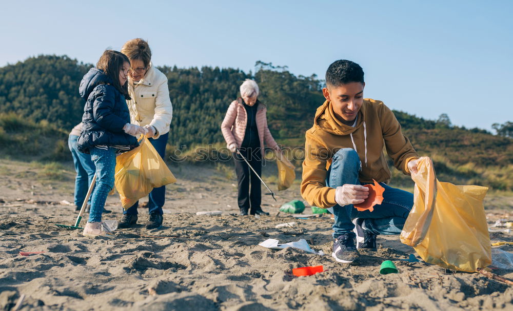 Young man cleaning the beach