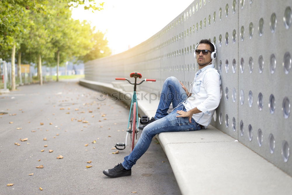 Similar – Front view of a young hipster woman sitting on a park bench relaxing in a sunny day while looking away