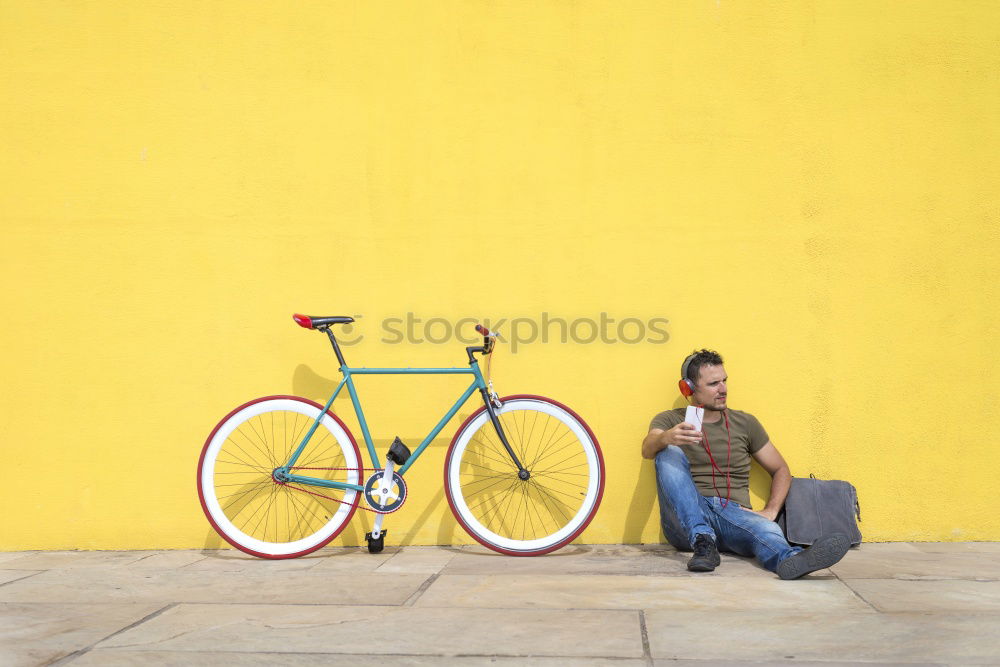 Similar – Side view of a young hipster man with a fixed bike