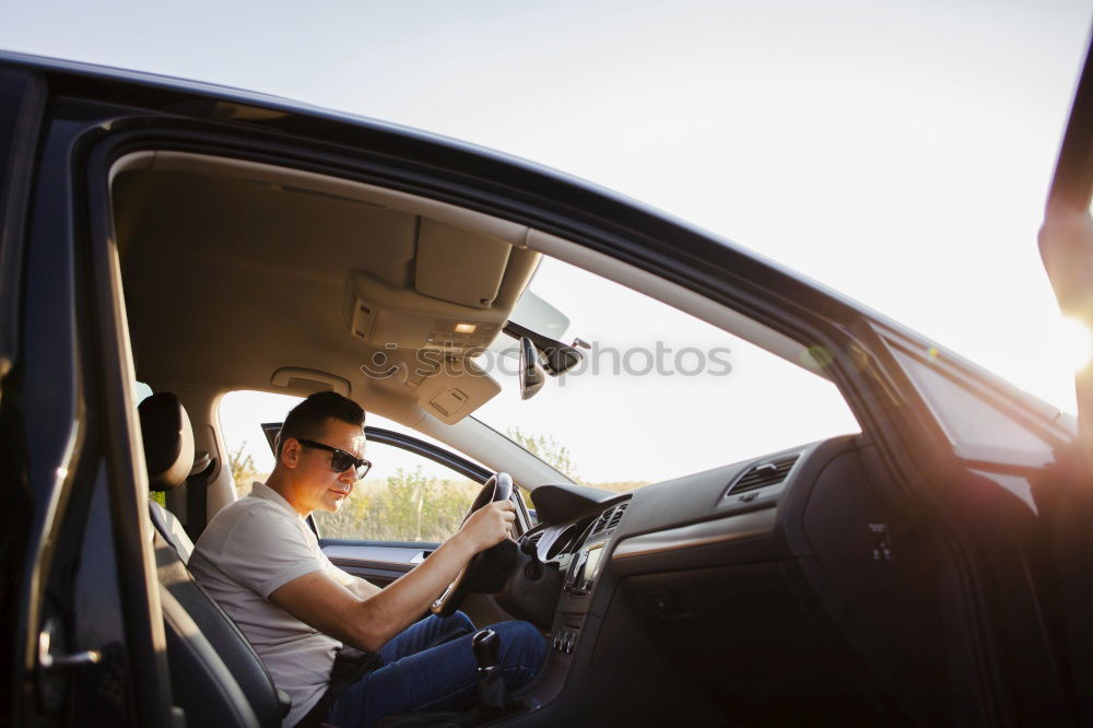 father teaching kid daughter to drive a car