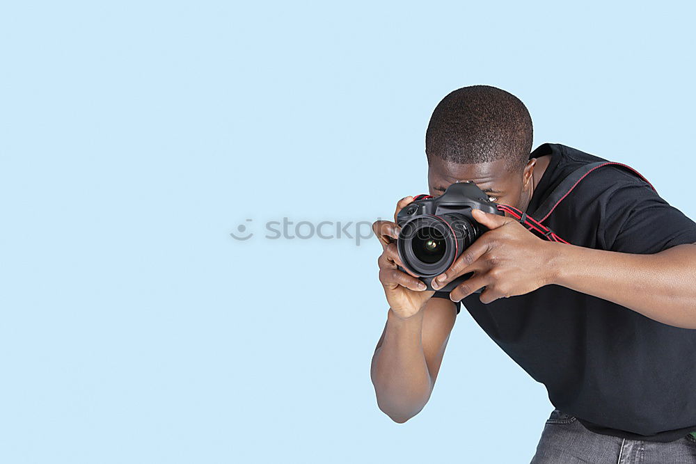 Similar – Young modern man sitting on halfpipe taking picture with Camera