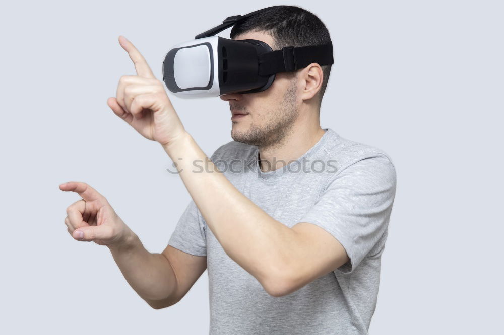 Similar – Foto Bild Ein Mann, der sich eine Virtual-Reality-Brille ansieht.