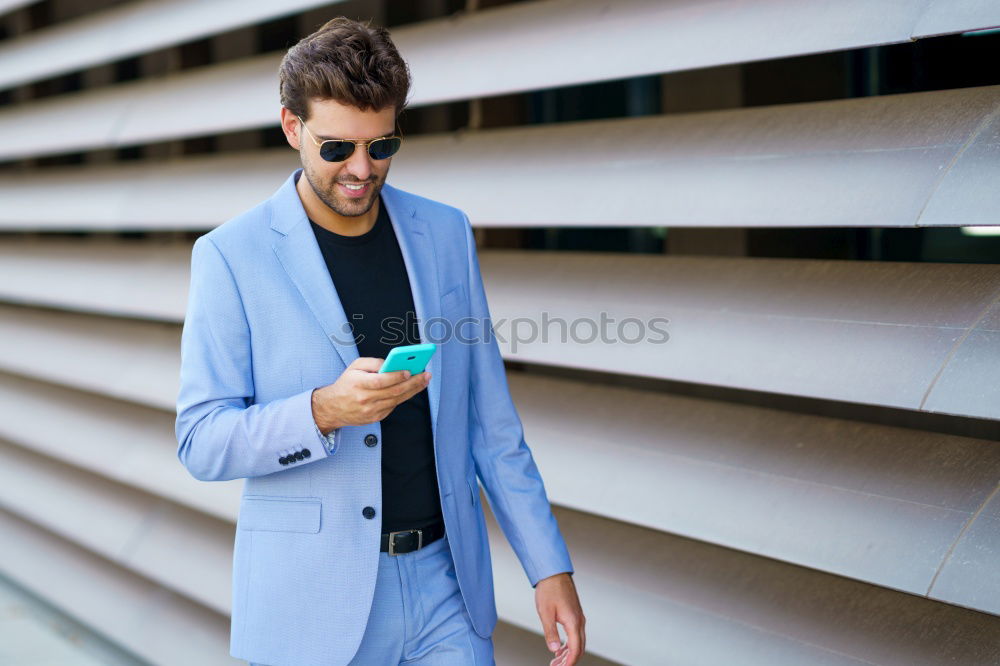 Similar – Image, Stock Photo Young smiling man looking at his smart phone outdoors
