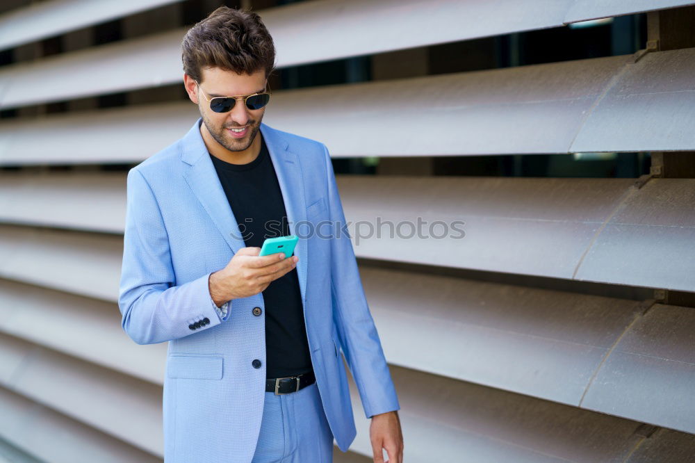 Similar – Image, Stock Photo Young smiling man looking at his smart phone outdoors