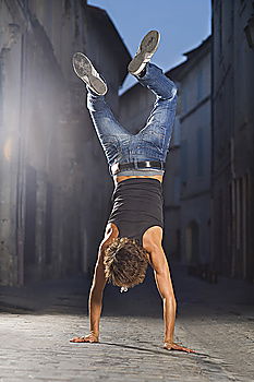 Similar – Shirtless man in handstand on street