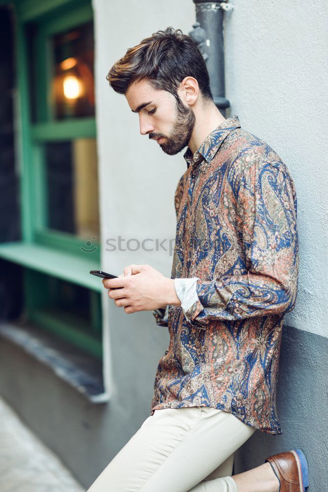 Similar – Image, Stock Photo Young smiling man looking at his smartphone in the street