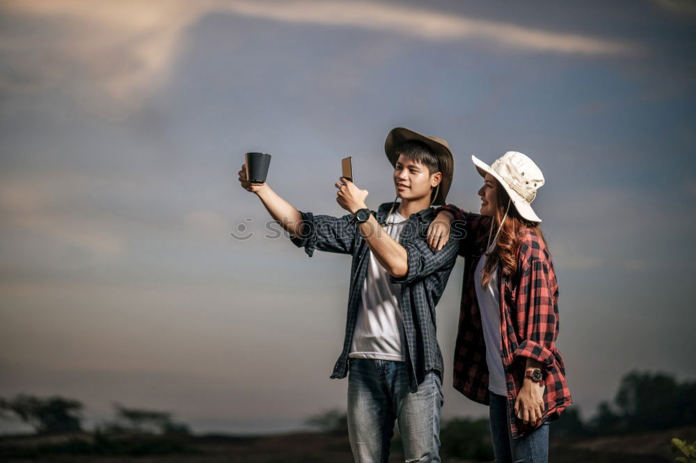 Similar – Image, Stock Photo Stylish women browsing phone on breathtaking landscape