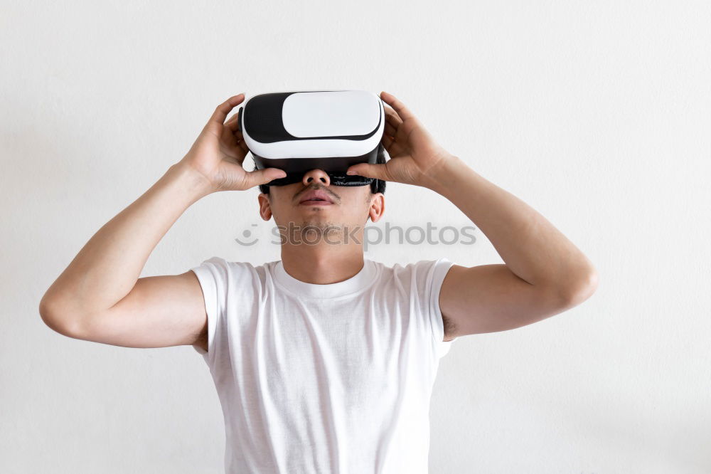 Similar – Foto Bild Ein Mann, der sich eine Virtual-Reality-Brille ansieht.