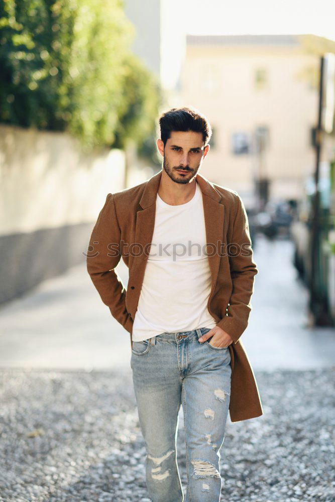 Young man wearing winter clothes in the street.