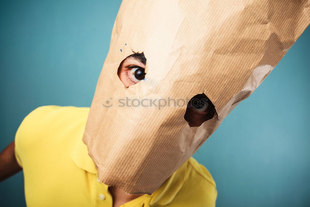 Similar – Person with paper bag on head pointing at camera