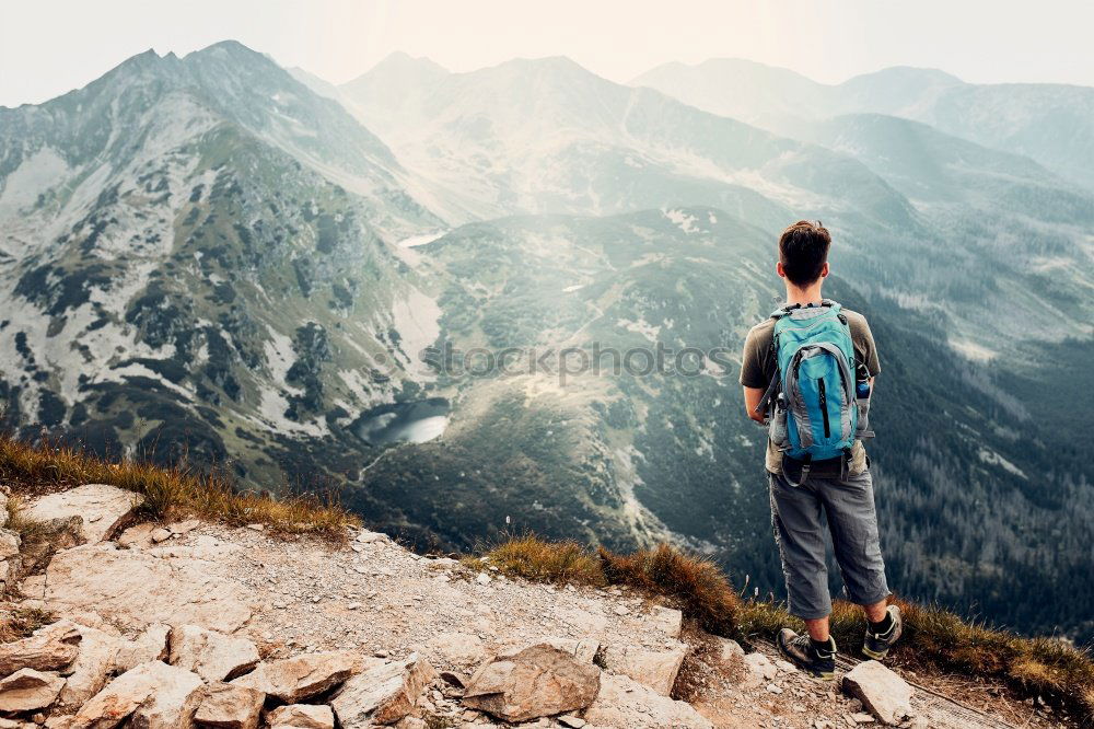 Similar – Image, Stock Photo Boy sitting on the rocks in the mountains and looking at a valley