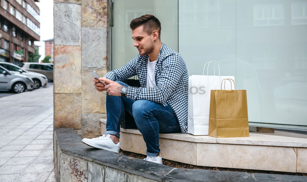 Similar – Image, Stock Photo Young smiling man looking at his smart phone outdoors