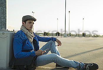 Similar – Young man sitting on the floor in urban background