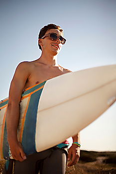 Similar – Man standing with skateboard at shore