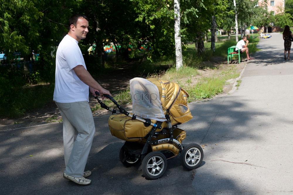 Similar – Foto Bild Oma spielt mit ihrem Enkel im Kinderwagen im Garten.