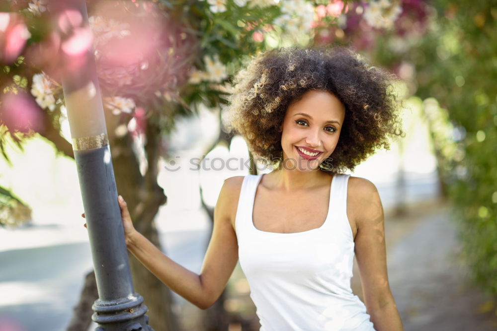 Similar – Image, Stock Photo Mixed female with afro hairstyle smiling in urban park.