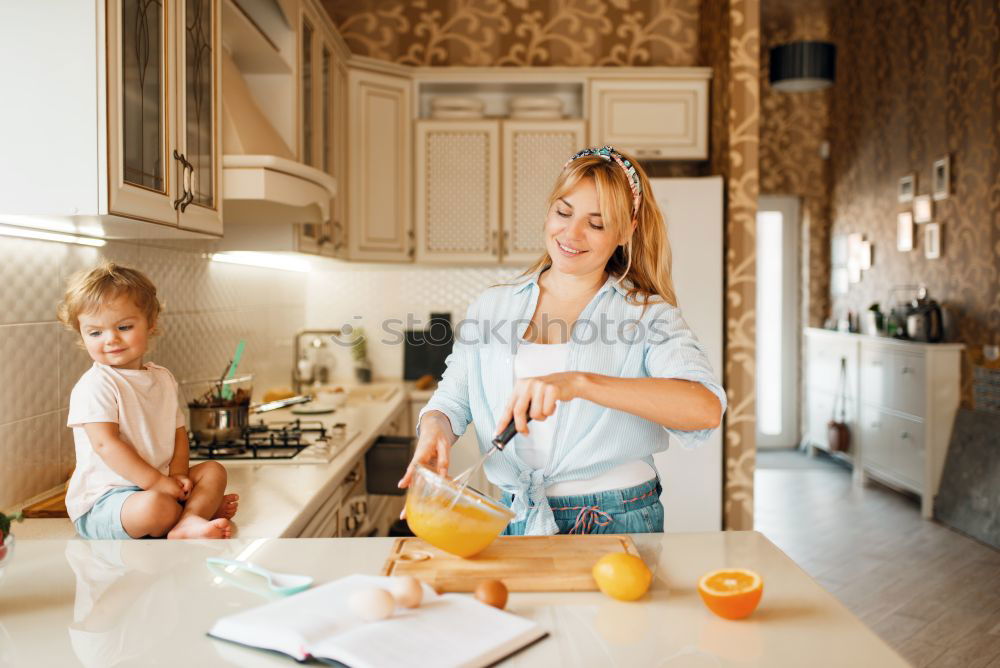 Similar – Mother and son baking together in kitchen