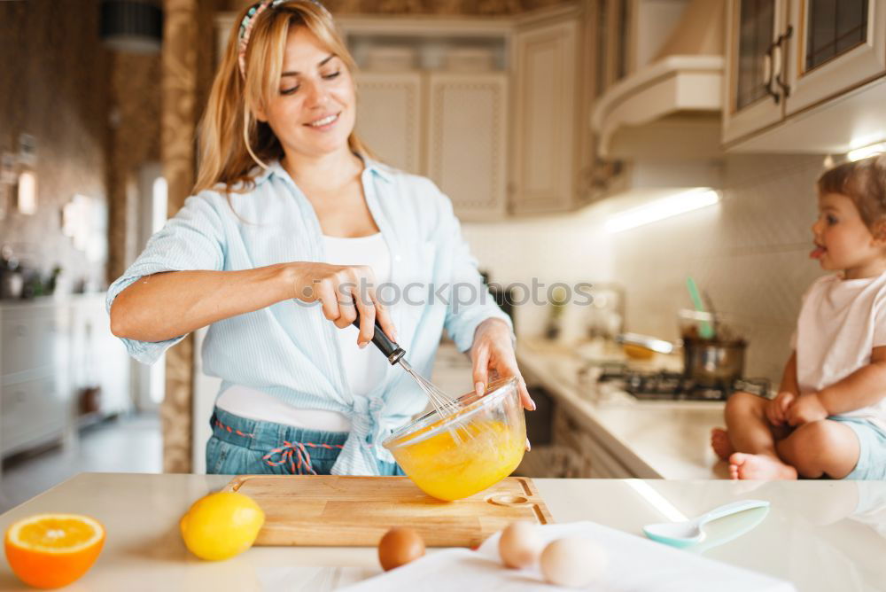 Similar – Image, Stock Photo Little sisters cooking with her mother in the kitchen.