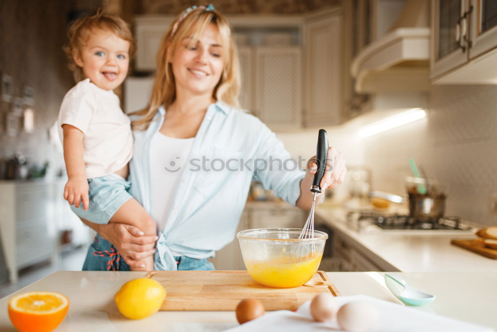 Similar – Image, Stock Photo Little sisters cooking with her mother in the kitchen.