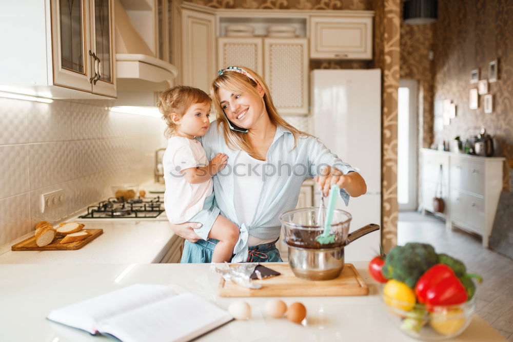 Similar – Mother and son baking together in kitchen