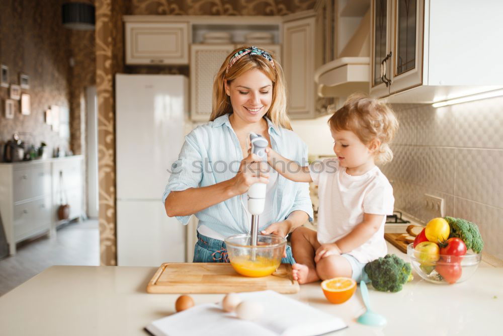 Similar – Mother and son baking together in kitchen