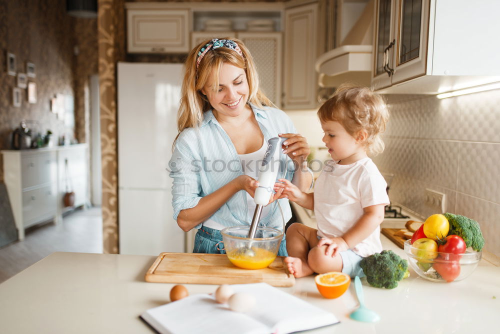 Similar – Mother and son baking together in kitchen