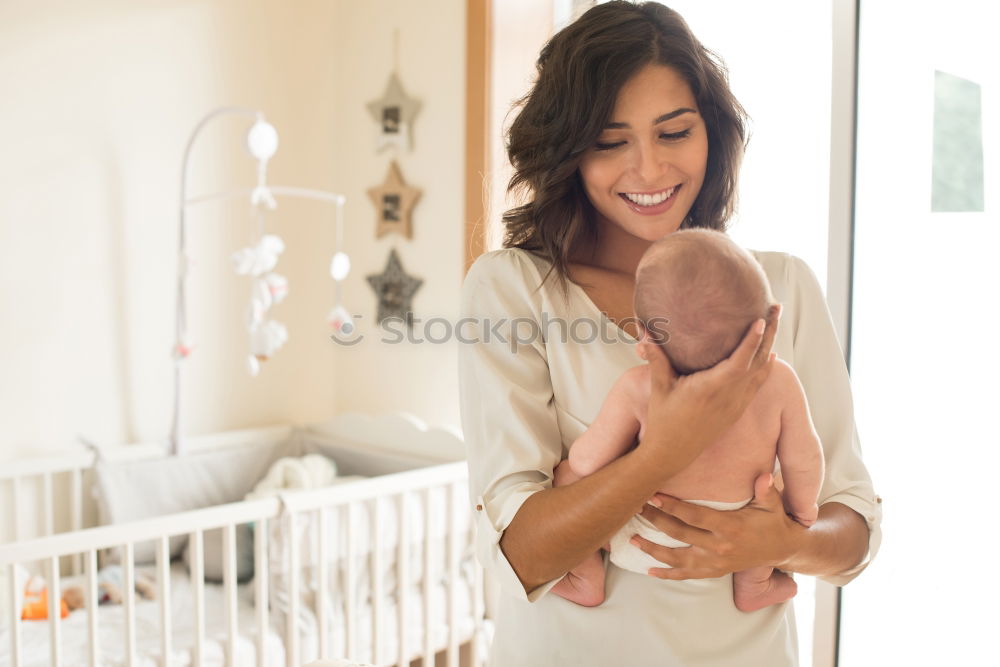 Similar – Image, Stock Photo Young mother holding her baby in the bedroom