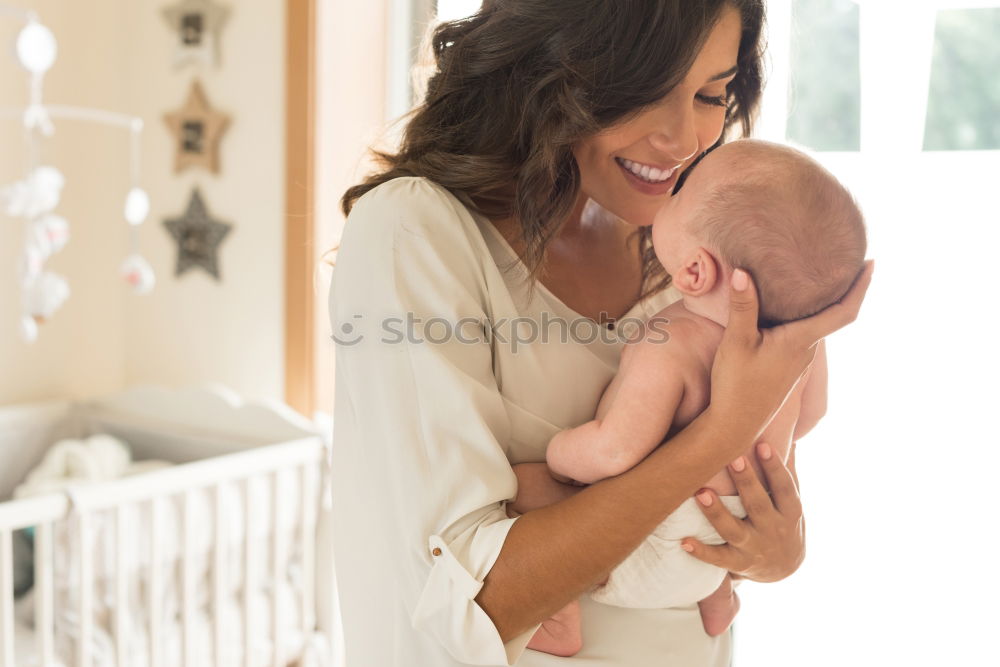 Image, Stock Photo Young mother holding her baby in the bedroom