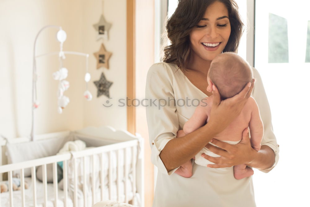 Similar – Image, Stock Photo Young mother holding her baby in the bedroom