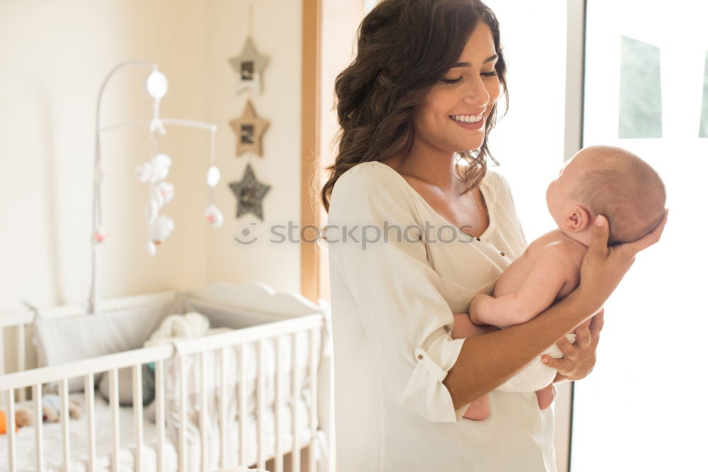 Similar – Image, Stock Photo Young mother holding her baby in the bedroom