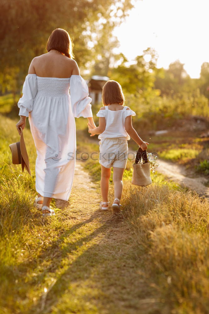 Mother holding walking child