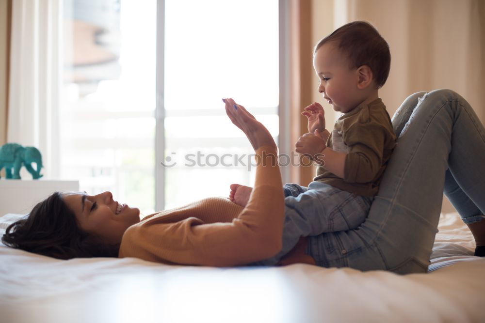 Similar – happy mother and child son fooling and playing in bed