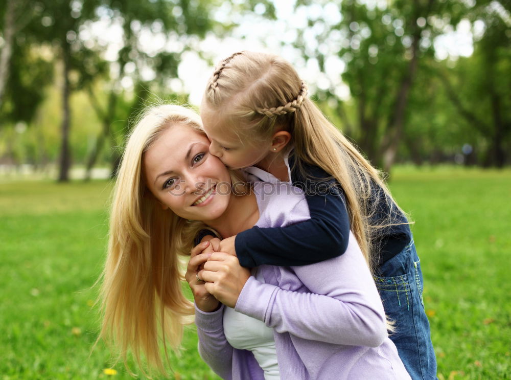 Similar – Kissing mother and daughter in summer