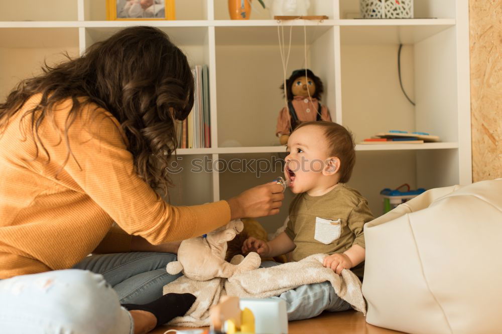 Similar – Girl and boy reading book sitting on bed