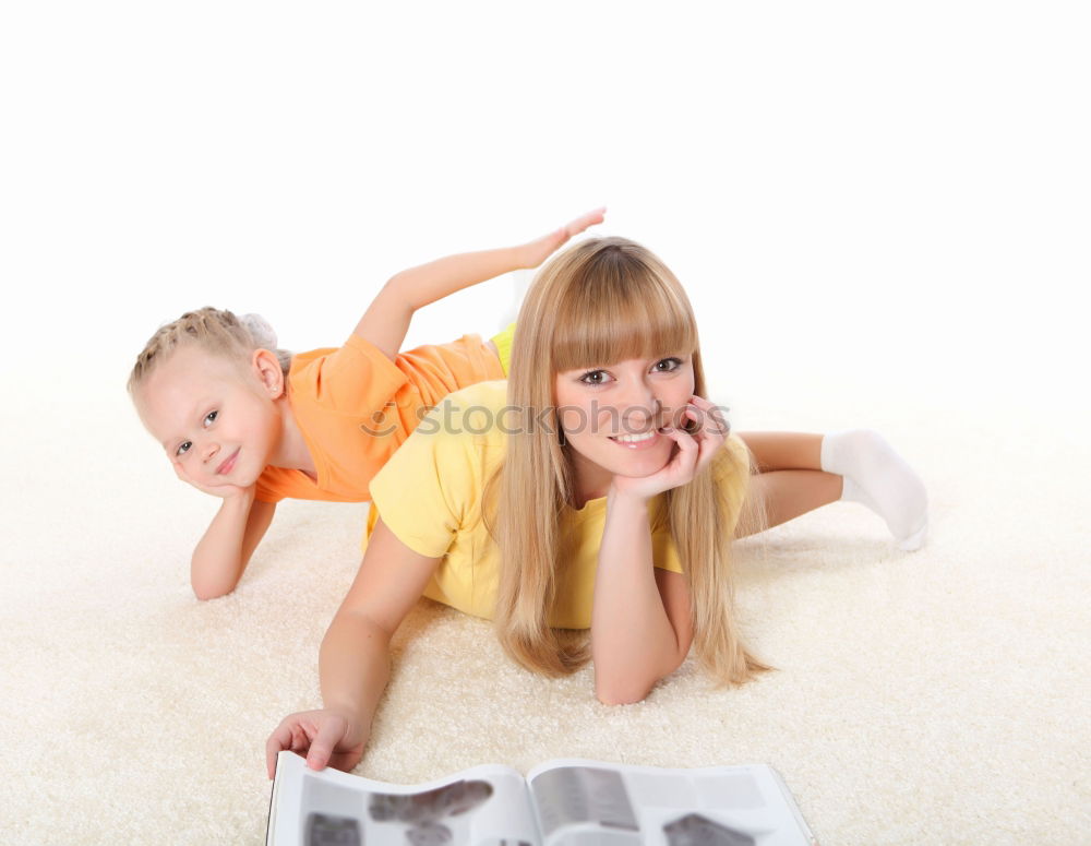 Similar – Image, Stock Photo A baby girl studies something on haunches, while her older brother watches her from upstairs sitting on the steps