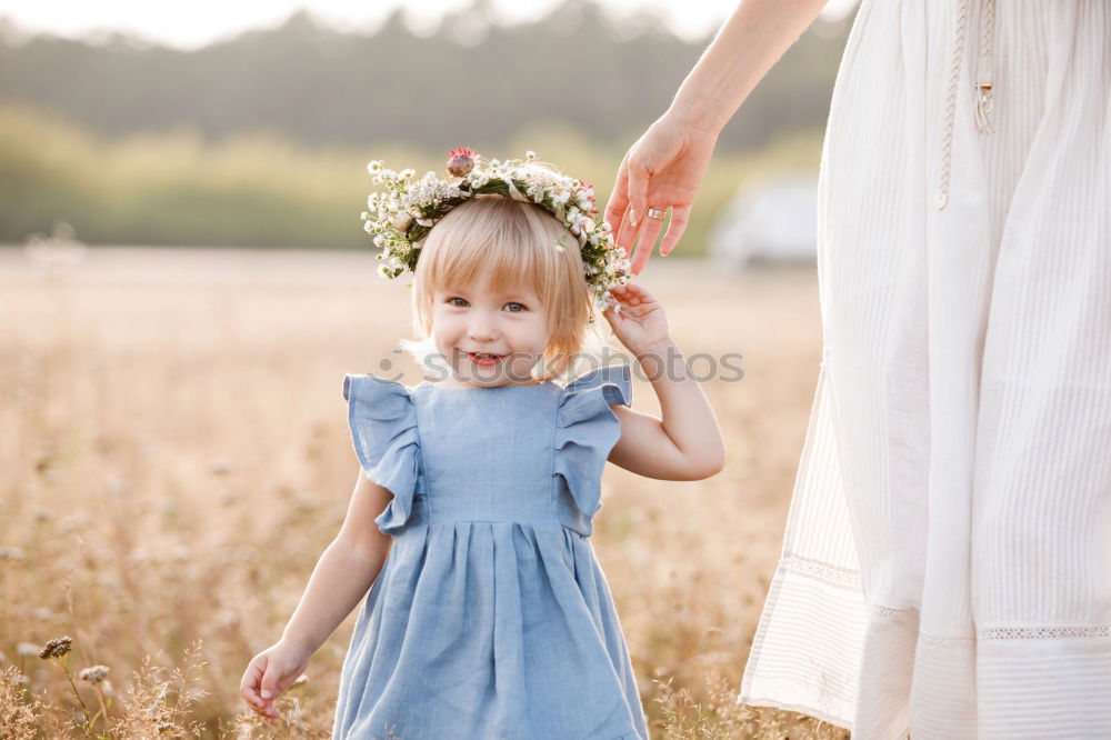 Similar – Baby girl holding finger of senior man hand