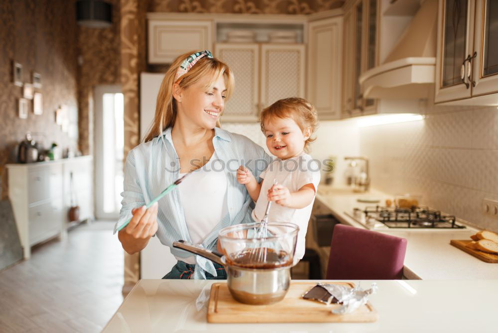 Similar – Mother and son baking together in kitchen