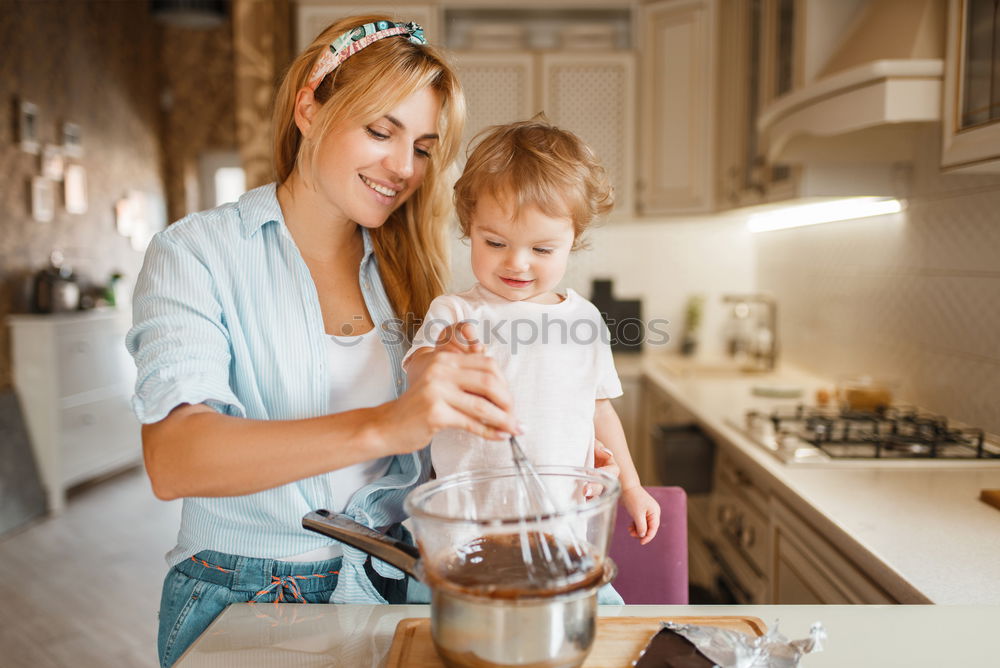 Similar – Mother and son baking together in kitchen