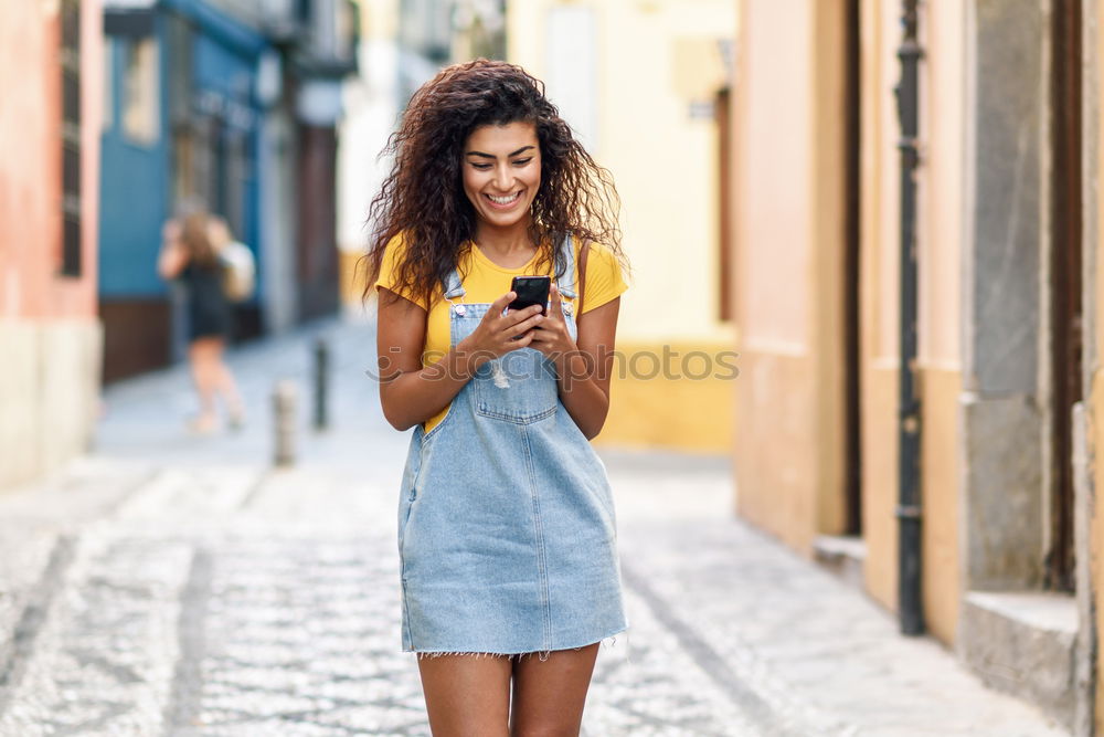 Image, Stock Photo African woman walking on the street looking at her smart phone