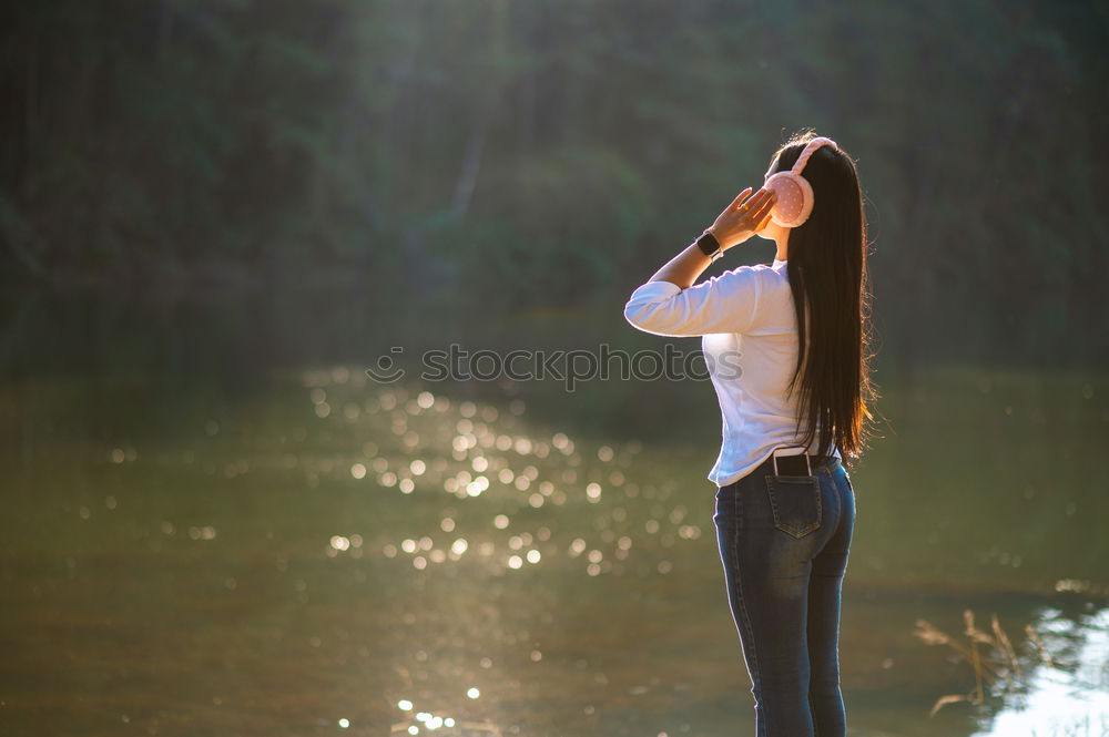 Similar – Woman looking out through a bridge, with a hand floating in the air.