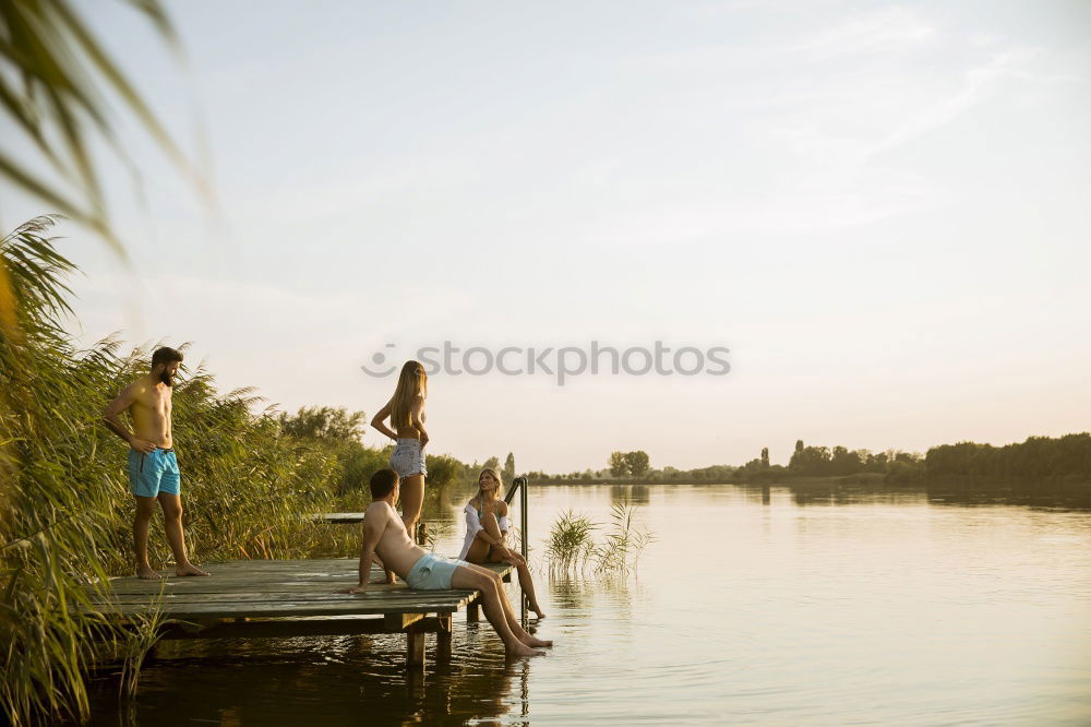 Similar – Two young men jump into the water