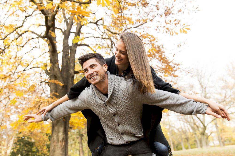 Similar – Happy girlfriend jumping on boyfriend’s back in the street